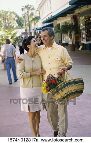 Stock Image - Mature couple walking together. Fotosearch