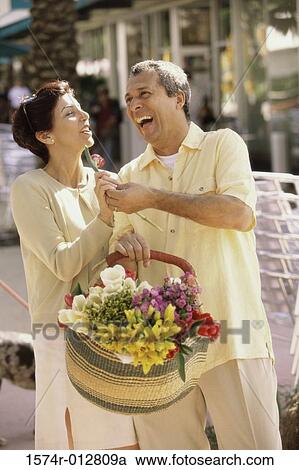 Mature man giving a flower to a mature woman View Large Photo Image Stock Image - Mature man giving a flower to a mature woman. Fotosearch