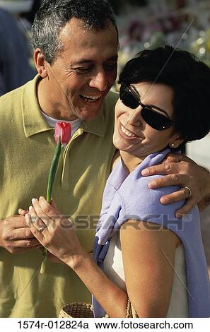 Mature man giving a flower to a mature woman View Large Photo Image Stock Image - Mature man giving a flower to a mature woman. Fotosearch