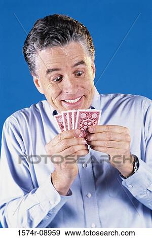 Mature man holding playing cards View Large Photo Image Stock Photo - Mature man holding playing cards. Fotosearch