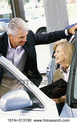 Mature man talking to a mature woman sitting in a car View Large Photo Image Stock Image - Mature man talking to a mature woman sitting in a car. Fotosearch