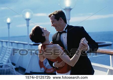 Mid adult couple dancing on the deck of a cruise ship View Large Photo Image Stock Image - Mid adult couple dancing on the deck of a cruise ship. Fotosearch