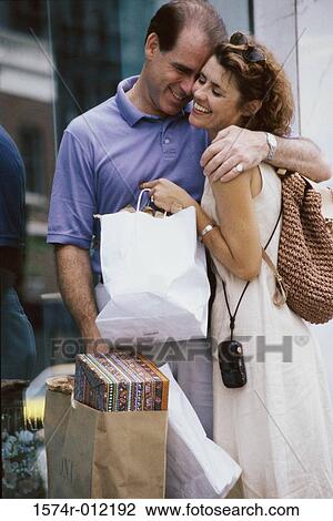Mid adult couple embracing View Large Photo Image Stock Image - Mid adult couple embracing. Fotosearch