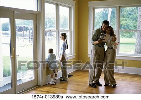 Mid adult couple reading a magazine smiling View Large Photo Image Stock Image - Mid adult couple reading a magazine smiling. Fotosearch