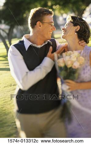 Mid adult couple smiling at each other View Large Photo Image Stock Image - Mid adult couple smiling at each other. Fotosearch
