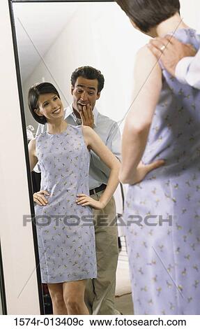 Mid adult couple standing in front of a mirror View Large Photo Image Stock Image - Mid adult couple standing in front of a mirror. Fotosearch