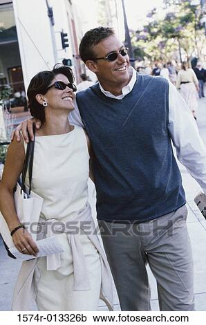 Mid adult couple walking together View Large Photo Image Stock Image - Mid adult couple walking together. Fotosearch