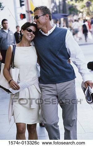 Mid adult couple walking together View Large Photo Image Stock Image - Mid adult couple walking together. Fotosearch