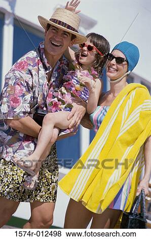 Mid adult couple with their daughter standing on a cruise ship smiling View Large Photo Image Stock Photo - Mid adult couple with their daughter standing on a cruise ship smiling. Fotosearch