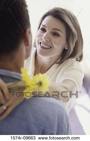 Mid adult woman holding a man around his neck View Large Photo Image Stock Image - Mid adult woman holding a man around his neck. Fotosearch