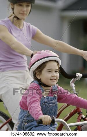 Mother and daughter riding bicycles View Large Photo Image Stock Image - Mother and daughter riding bicycles. Fotosearch