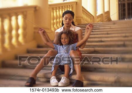 Mother and daughter sitting on steps View Large Photo Image Stock Image - Mother and daughter sitting on steps. Fotosearch
