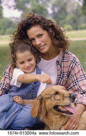 Mother and daughter sitting with their dog View Large Photo Image Stock Image - Mother and daughter sitting with their dog. Fotosearch
