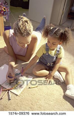Mother and her daughter coloring with crayons View Large Photo Image Stock Photograph - Mother and her daughter coloring with crayons. Fotosearch