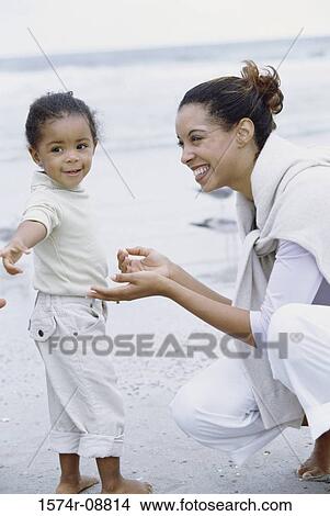 Mother and her daughter playing together at the beach View Large Photo Image Picture - Mother and her daughter playing together at the beach. Fotosearch