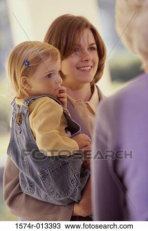 Mother carrying her daughter and smiling View Large Photo Image Stock Image - Mother carrying her daughter and smiling. Fotosearch
