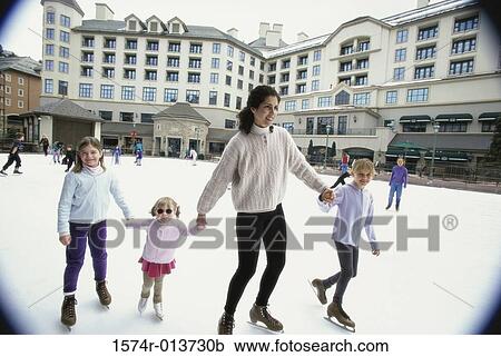 Mother ice skating with her three daughters View Large Photo Image Stock Image - Mother ice skating with her three daughters. Fotosearch