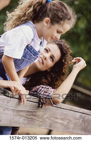 Stock Photography - Mother looking at her daughter. Fotosearch