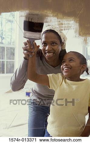 Mother teaching her daughter to paint View Large Photo Image Stock Image - Mother teaching her daughter to paint. Fotosearch