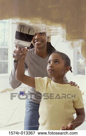 Mother teaching her daughter to paint View Large Photo Image Stock Photo - Mother teaching her daughter to paint. Fotosearch