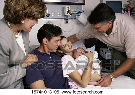 Stock Photography - New born baby boy with his parents and grandparents in a hospital. Fotosearch