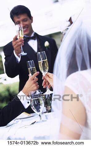 Newlywed couple and a wedding guest toasting with champagne View Large Photo Image Stock Image - Newlywed couple and a wedding guest toasting with champagne. Fotosearch