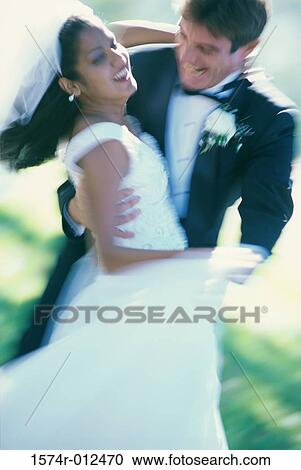 Stock Image - Newlywed couple dancing. Fotosearch