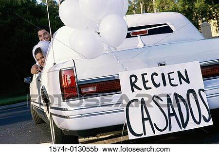 Stock Image - Newlywed couple leaving for a honeymoon. Fotosearch