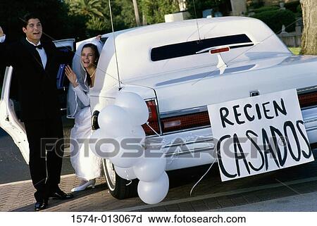 Stock Image - Newlywed couple leaving for a honeymoon. Fotosearch