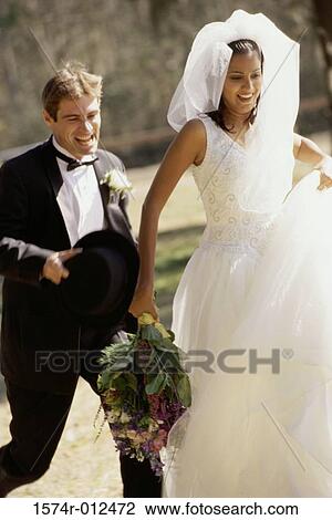 Newlywed couple running View Large Photo Image Stock Image - Newlywed couple running. Fotosearch