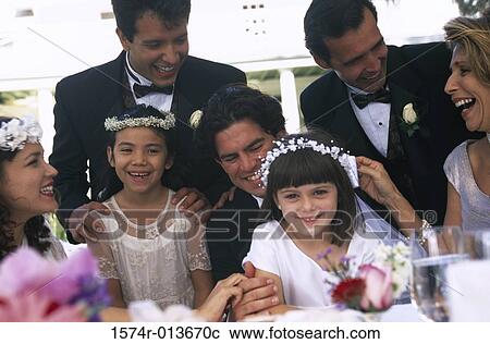 Newlywed couple sitting with wedding guests View Large Photo Image Stock Image - Newlywed couple sitting with wedding guests. Fotosearch