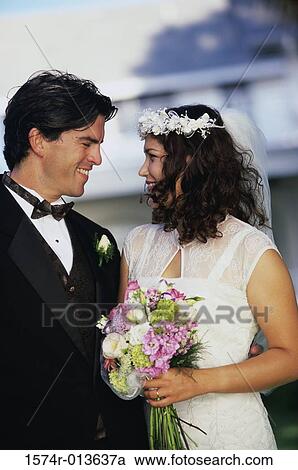 Newlywed couple smiling at each other View Large Photo Image Stock Image - Newlywed couple smiling at each other. Fotosearch