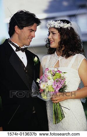 Newlywed couple smiling at each other View Large Photo Image Stock Image - Newlywed couple smiling at each other. Fotosearch