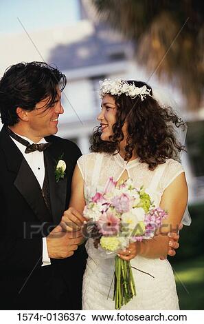 Newlywed couple smiling at each other View Large Photo Image Stock Image - Newlywed couple smiling at each other. Fotosearch