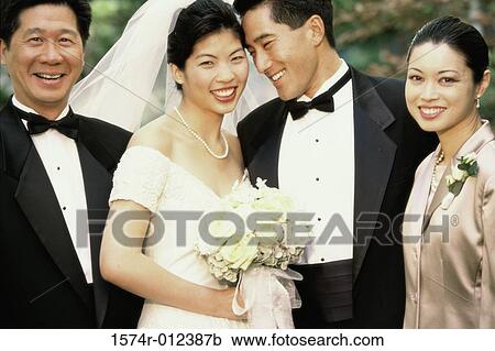 Newlywed couple standing with wedding guests View Large Photo Image Stock Image - Newlywed couple standing with wedding guests. Fotosearch