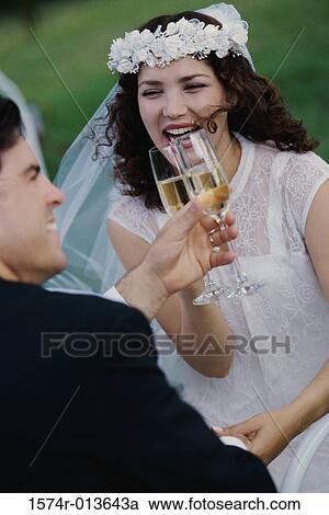 Newlywed couple toasting with champagne View Large Photo Image Stock Image - Newlywed couple toasting with champagne. Fotosearch