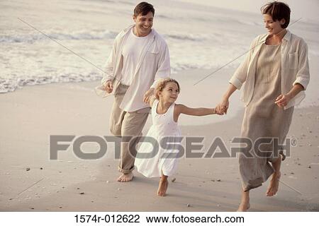 Parents and their daughter running on the beach View Large Photo Image Stock Image - Parents and their daughter running on the beach. Fotosearch