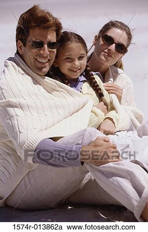 Parents and their daughter sitting on the beach View Large Photo Image Stock Image - Parents and their daughter sitting on the beach. Fotosearch