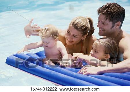 Parents and their two daughters in a swimming pool View Large Photo Image Stock Image - Parents and their two daughters in a swimming pool. Fotosearch