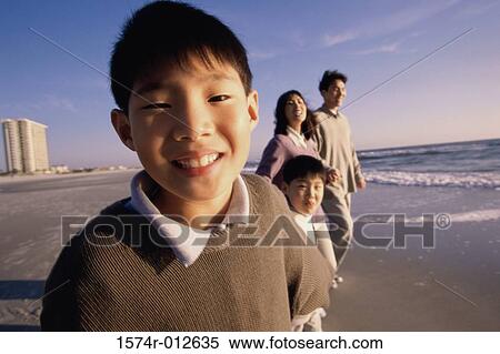 Parents and their two sons walking on the beach View Large Photo Image Stock Photography - Parents and their two sons walking on the beach. Fotosearch