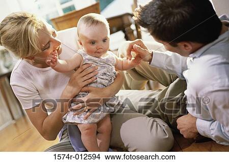 Parents looking at their daughter smiling View Large Photo Image Picture - Parents looking at their daughter smiling. Fotosearch