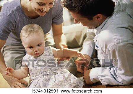Parents looking at their daughter smiling View Large Photo Image Stock Image - Parents looking at their daughter smiling. Fotosearch
