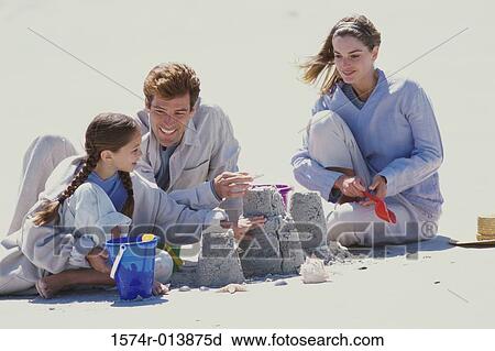 Parents playing with their daughter on the beach View Large Photo Image Stock Image - Parents playing with their daughter on the beach. Fotosearch