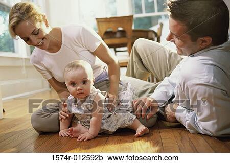 Stock Image - Parents playing with their daughter. Fotosearch