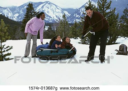 Parents pulling an inflatable tube with their two daughters View Large Photo Image Stock Image - Parents pulling an inflatable tube with their two daughters. Fotosearch