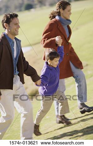 Parents running with their son in a park View Large Photo Image Stock Image - Parents running with their son in a park. Fotosearch