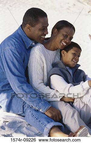Parents sitting with their son View Large Photo Image Stock Photograph - Parents sitting with their son. Fotosearch