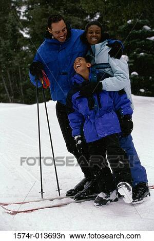 Parents standing with their son in snow View Large Photo Image Picture - Parents standing with their son in snow. Fotosearch
