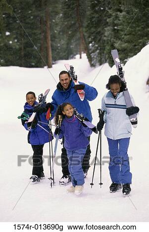 Parents walking with their two children in snow View Large Photo Image Stock Image - Parents walking with their two children in snow. Fotosearch