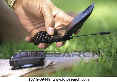Person holding a mobile phone View Large Photo Image Stock Photo - Person holding a mobile phone. Fotosearch